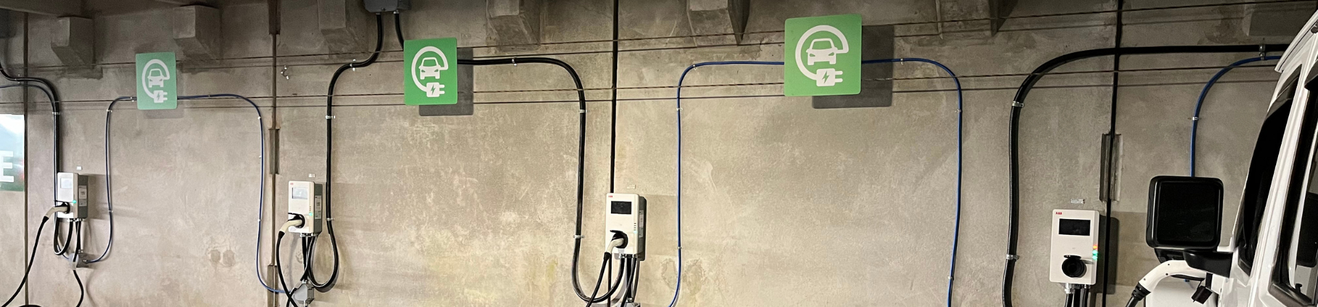 A photo of electric charging outlets in a parking garage