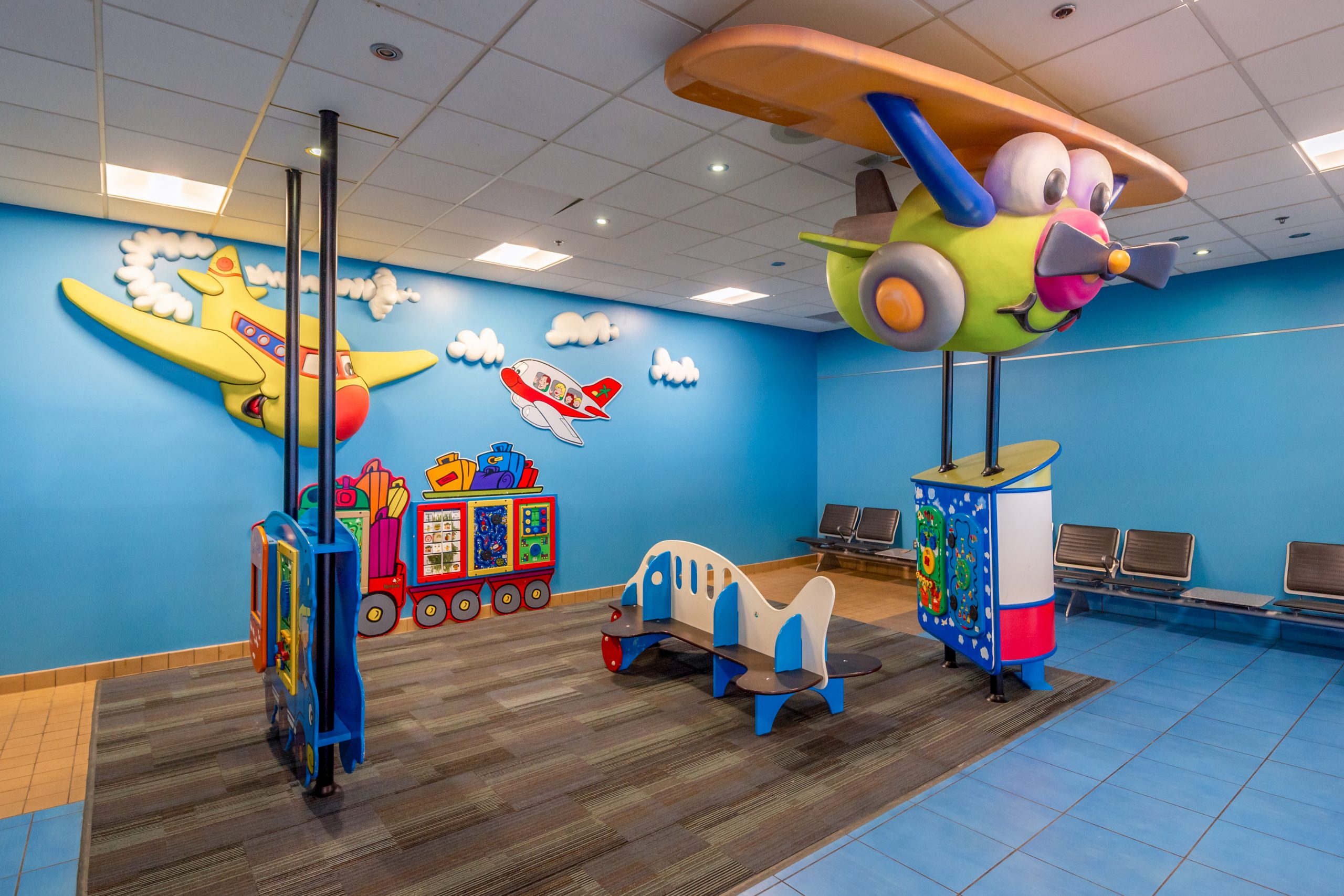 A children's play area at the airport, featuring colourful, aviation-themed play equipment.